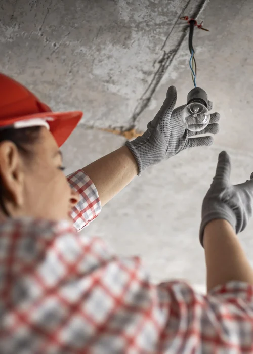 low-angle-female-construction-worker-with-light-bulb